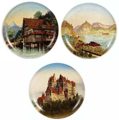 Three Mettlach plaques, all 12.0" d., 527/1044, Wirtschaft zum Treib am Vierwalderstättersee, a little browning; with, 160/1044, Rolandseck Siebengebirge, a little browning; with, 95/1044, Burg Eltz, 1" hairline visible on rear.