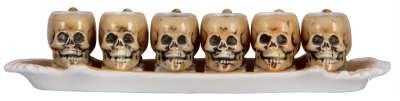 Porcelain schnapps beakers, 10" l., marked E. Bohne Söhne, tray with six Character Skull beakers, mint.