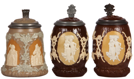 Three Mettlach steins, .5L, 1467, relief, inlaid lid; with two, .5L, 1028, relief, inlaid lids, all mint.