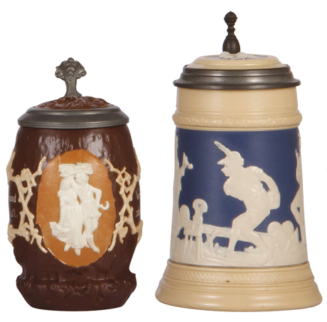 Two Mettlach steins, .5L, 1028 & 2182, relief, inlaid lids, 1028 has browning, 2182 has popped factory blister, otherwise mint.