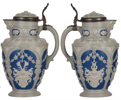 Two Mettlach steins, 3.0L, 13.2'' ht., 2076, relief, inlaid lid, pewter tear repair not complete, inlay crack, repair; with, 3.0L, 13.2'' ht., 1821, relief, inlaid lid, cracks repaired, some paint peeling. - 2