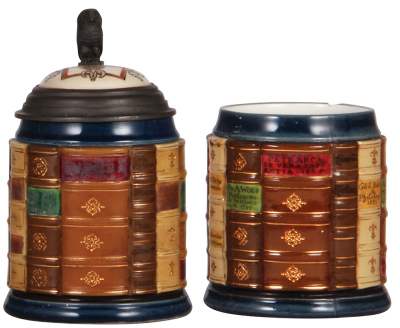 Two Mettlach steins, .5L, 2001K, decorated relief, inlaid lid, Commerce Book Stein, 2" line on inside bottom; with, .5L, 2001C, decorated relief, no lid, Scholar Book Stein, .5" chip top rim.