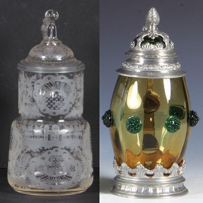 Two glass steins, .5L, blown, clear, wheel-engraved, matching glass inlaid lid, mint; with, .5L, blown, amber, applied green glass prunts, matching glass inlaid lid with overlay, mint.