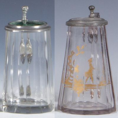 Two glass steins, 4.5'' ht., blown, clear, faceted, green glass inlaid lid, inlay flake, body mint; with, 4.4'' ht., blown, clear, mid 1800s, faceted, hand-painted, gilded scene, matching glass inlaid lid, pewter strap repaired, otherwise mint.