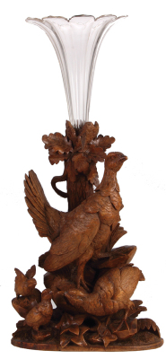 Black Forest bird vase, wood carving 16.5" ht., overall 24.0" ht., 11.0" w. x 7.0" d., carved in Switzerland, c.1910, linden wood, blown and cut trumpet glass insert, bird family, chips on base and feather, very good condition.