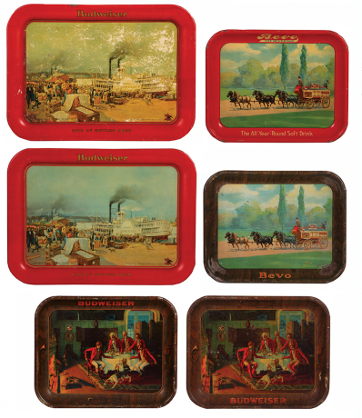 Six Anheuser Busch trays, sizes 10.5" x 13.0" and 17.4" x 12.7", all have lithographs, St. Louis Levee in early seventies, Bevo, men by fire after the hunt, all in used condition.