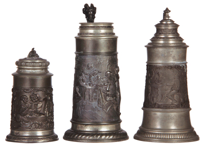 Three pewter steins, .5L & 1.0L, relief scenes, monks & gnomes drinking, tavern scene, tavern scene, normal wear, good condition.    