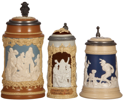 Three Mettlach steins, 1.0L, 812, relief, inlaid lid, mint; .5L, 1005, relief, inlaid lid, interior glaze is brown, otherwise mint; .5L, 2182, inliad lid, mint.