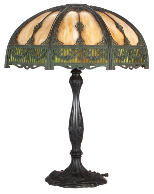 Table lamp, 24.7" ht., 25.3" d., marked #537 on base, in the style of Handel, multi-colored slag glass with elaborate shade metalwork, two bulb sockets, excellent condition.