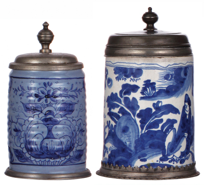 Two Faience steins, 8.2'' ht., mid 1700s, marked: K, Walzenkrug, ribbed body, pewter lid & footring, pewter strap repaired, 1'' hairline & a couple of small rim chips; with, 9.0'' ht., mid 1700s, Walzenkrug, pewter lid & footring, two 1'' hairlines, well 