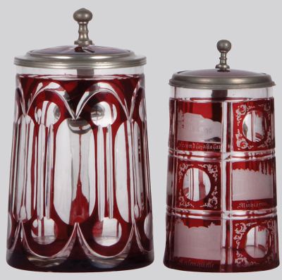 Two glass steins, .5L, blown, clear, red stained, cut, matching glass inlaid lid, mint; with, .4L, blown, clear, red stained, engraved, Carlsbad, red glass inlaid lid, pewter strap glued, otherwise mint.