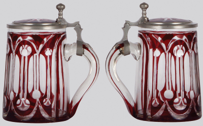 Two glass steins, .5L, blown, clear, red stained, cut, matching glass inlaid lid, mint; with, .4L, blown, clear, red stained, engraved, Carlsbad, red glass inlaid lid, pewter strap glued, otherwise mint. - 2